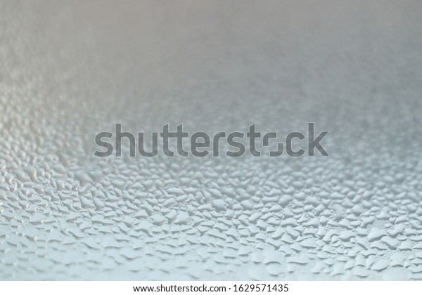 Closeup on fog condensation on window glass
background. Depth of
field