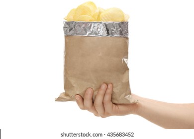 Close-up On A Hand Holding A Brown Bag Full Of Potato Chips Isolated On White Background