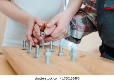 Closeup on hand of man in occupational therapy screwing nut on bolt