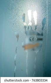 Closeup On Hand Palm Print Mark On Window Glass With Condensation, Rain Or Water Drops And Steam Surface Textured Abstraction Background