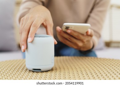 Close-up On Hand Using Phone Connecting Portable Speaker