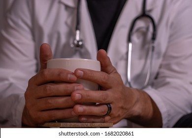 Close-up On Hands Of Doctor Holding Coffee