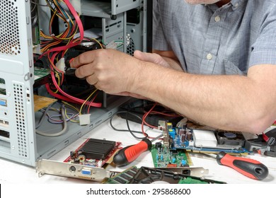 close-up on the hands of the technician repairing a computer