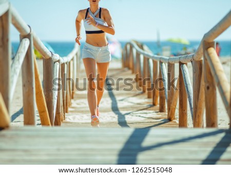 Similar – Fit healthy athletic woman jogging on a river bank