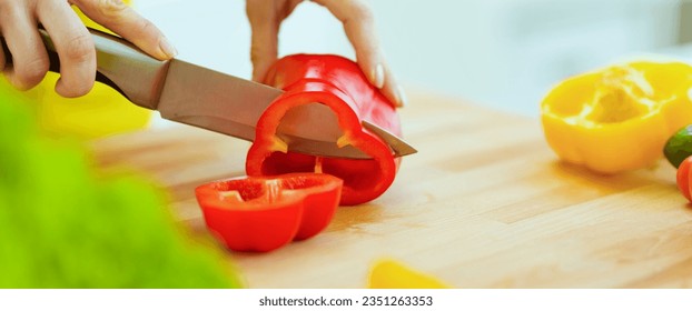 Closeup on housewife cutting red bell pepper on cutting board - Powered by Shutterstock