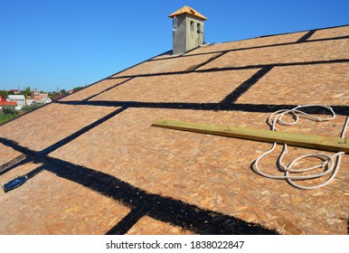 A close-up on an incomplete roofing construction on the stage of roof sheathing with self-adhering rubberized asphalt flexible flashings installed. - Shutterstock ID 1838022847