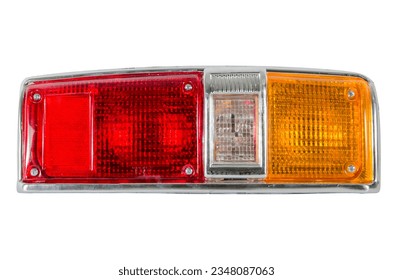 Close-up on an isolated generic rear light of a car and truck taillight optical equipment with a lamp inside on a white isolated background. Spare part for auto repair in a car workshop.  