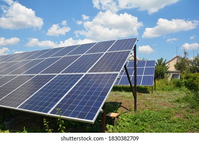 A close-up on large ground mounted solar panels, renewable energy source installed near the house instead of a vegetable garden. 