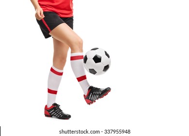 Close-up on the legs of a female football player jugling with a ball isolated on white background  - Powered by Shutterstock