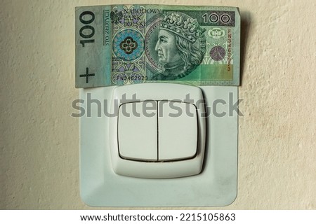 Closeup on light switch on wall in home. Concept high prices electricity, polish money. Price rise energy. Saving current. Energy crisis in Poland.