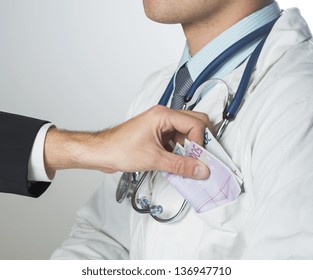 Closeup on medical doctor hands, taking money - Shutterstock ID 136947710