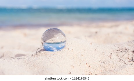 Close-up On Mini Glass Ball On The Beach