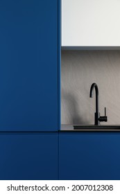 Close-up On Modern Designed Kitchen With Navy Blue Kitchen Furniture, Fridge And Stylish Black Sink With Black Tap