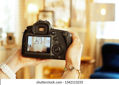 Closeup On Modern DSLR Camera In Hand Of Modern Female Interior Photographer At Home.