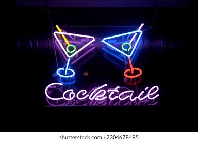 Close-up on a neon light shaped into two cocktail glasses above the word "Cocktails". - Shutterstock ID 2304678495