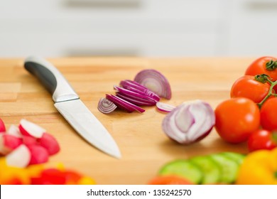 Closeup on onion and knife on cutting board