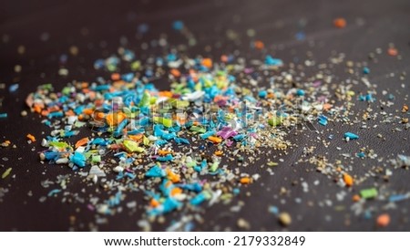 Close-up on a pile of micro plastic particles. Concept for water pollution and global warming. Macro shot on a bunch of microplastics that cannot be recycled.