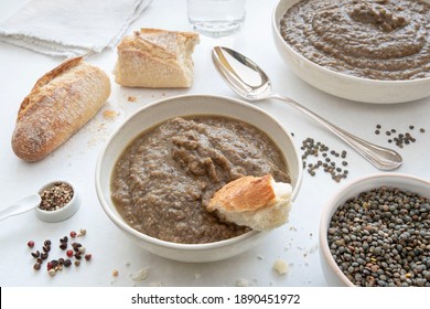 Close-up On A Plate Of Soup Or Lentil Purée With Bread And A Spoon