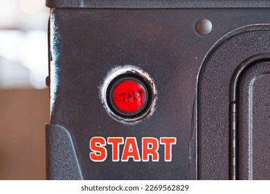 Close-up on a push start button of a vintage pinball machine.