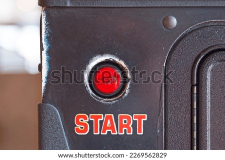 Close-up on a push start button of a vintage pinball machine.
