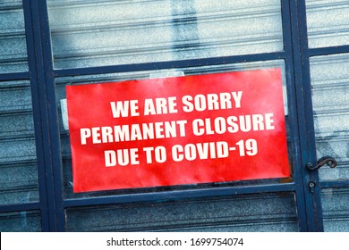 Close-up on a red closed sign in the window of a shop displaying the message "Permanent closure due to covid-19" - Shutterstock ID 1699754074