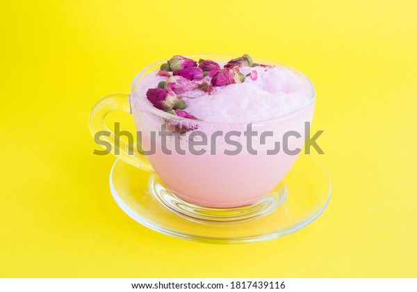 Closeup on rose moon milk in glass cup on the\
yellow background