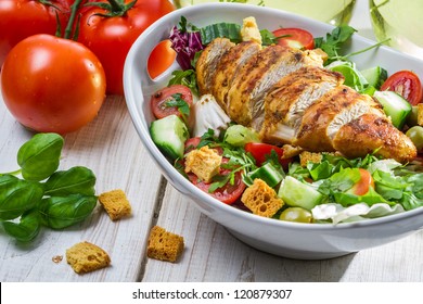 Close-up on a salad with chicken and tomato