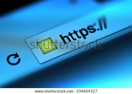 Closeup on the screen with depth of field and focus on the magnifying glass. The image is a security concept in the search engine and web browser address. Hyper Text Transfer Protocol Secure (https).