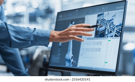 Close-Up On Screen Of Desktop Computer With Automation Software For Autonomous Assembly Line At Modern Factory With Robotic Arms. Technical Supervisor Pointing At Display, Adjusting Production Process