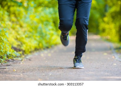 Close-up On Shoe Of Athlete Runner Man Feet Running On Road 