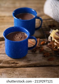 Close-up. On A Simple Wooden Table, A Cozy Composition - Two Blue Cups Of Coffee, Cocoa, Hot Chocolate, Sweets, Cinnamon Sticks And Star Anise. Cozy Family Evening, Morning, Romantic Date.