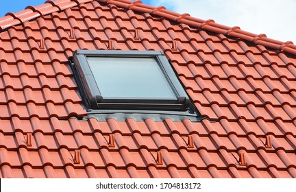 A Close-up On A Skylight Installation On The Ceramic Tiled, Clay Tiled Red Rooftop. 