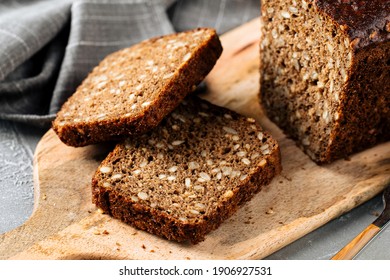 Closeup on sliced rye whole grain bread with seeds on the wooden board
