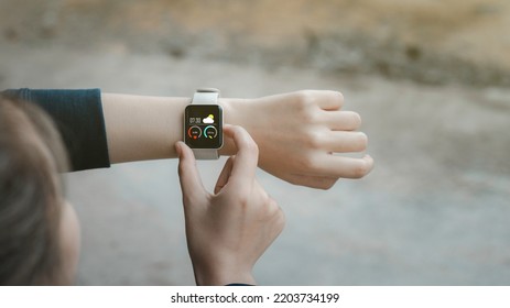 Close-up On Smart Watch Wear On Wrist Screen Show Heartbeat Tracking Technology, Walking Step, Time, Weather For  Data Health Checking With Fitness Activity App.