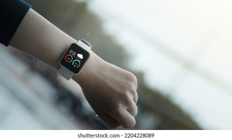 Close-up On Smart Watch Wear On Wrist Screen Show Heartbeat Tracking Technology, Walking Step, Time, Weather For  Data Health Checking With Fitness Activity App.