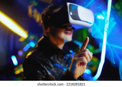 Closeup On Smiling Stylish 40 Years Old Woman In Virtual Reality In Vr Headset Pressing The Button In The Air.