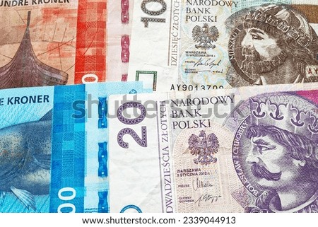 Close-up on a stack of Norwegian Krone and Polish Zloty.