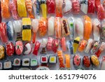Close-up on sushi and onigiri magnet. Artificial food made by wax. Shop window display, souvenir, restaurant menu food sample. Kappabashi dori, Tokyo, Japan.