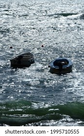 A close-up on a tiny boat in a small harbor.