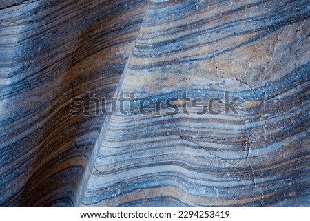 Closeup on a undulating abstract geologic pattern in a rock wall smoothed by eons of erosion, Death Valley National Park, California