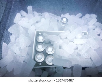 Closeup On Vials With Crimp Caps Placed On Dry Ice Prepared For Medical Transport. Selected Focus.