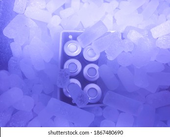 Closeup On Vials With Crimp Caps Placed On Dry Ice Prepared For Medical Transport. Photo In Blue Hue. Selected Focus.