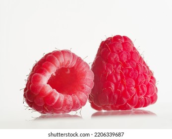 Close-up. On A White Background, Two Berries Of Juicy Ripe Raspberries. Vitamins, Antioxidants, Healthy Food, Healthy Lifestyle, Sweet Dessert. There Are No People In The Photo.