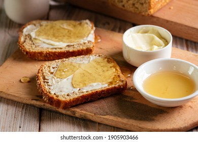 Closeup on whole grain bread slices spred with butter and honey - Shutterstock ID 1905903466