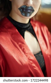 Closeup On Woman With Black Hydrogel Lip Mask In The Living Room In Sunny Day.