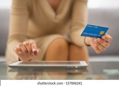 Closeup On Woman With Credit Card Using Tablet Pc