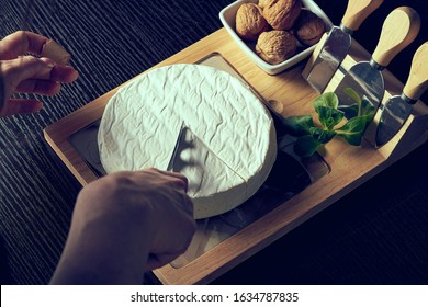 Closeup on woman cutting fresh cheese. - Powered by Shutterstock