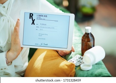 Closeup On Woman In The Living Room In Sunny Day Showing Electronic Prescription On A Tablet PC.