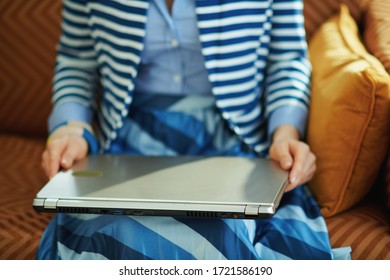 Closeup On Woman Sitting On Couch With Closed Laptop At Home In Sunny Day.