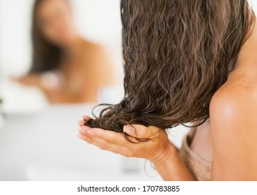 Closeup On Young Woman Applying Hair Mask